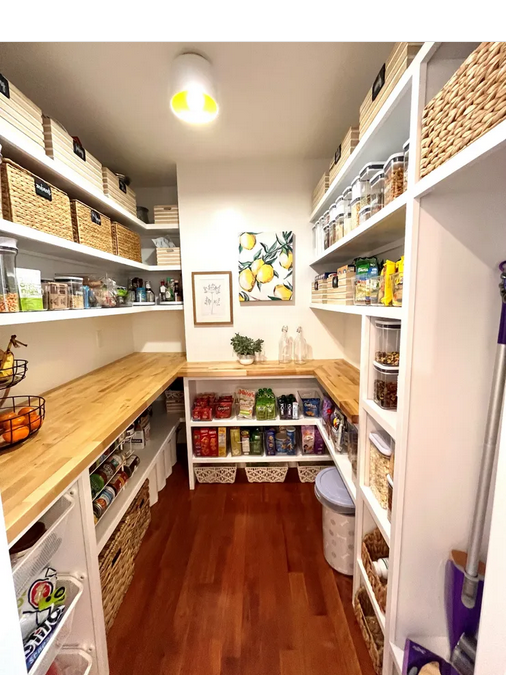 A pantry with lots of shelves and baskets.