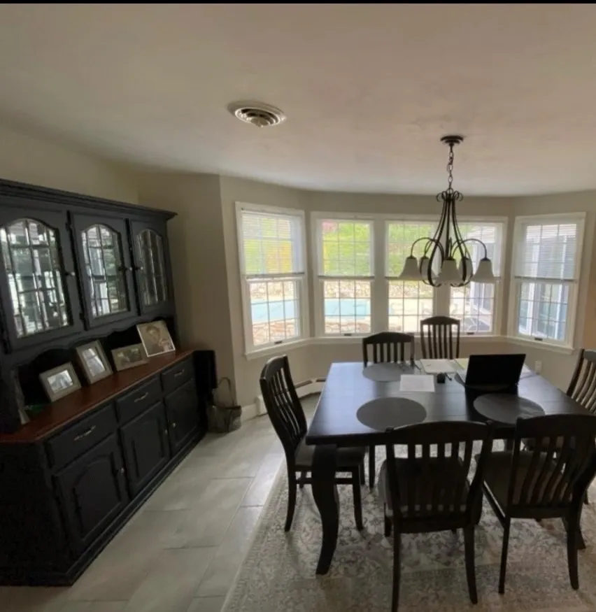 A dining room with black table and chairs