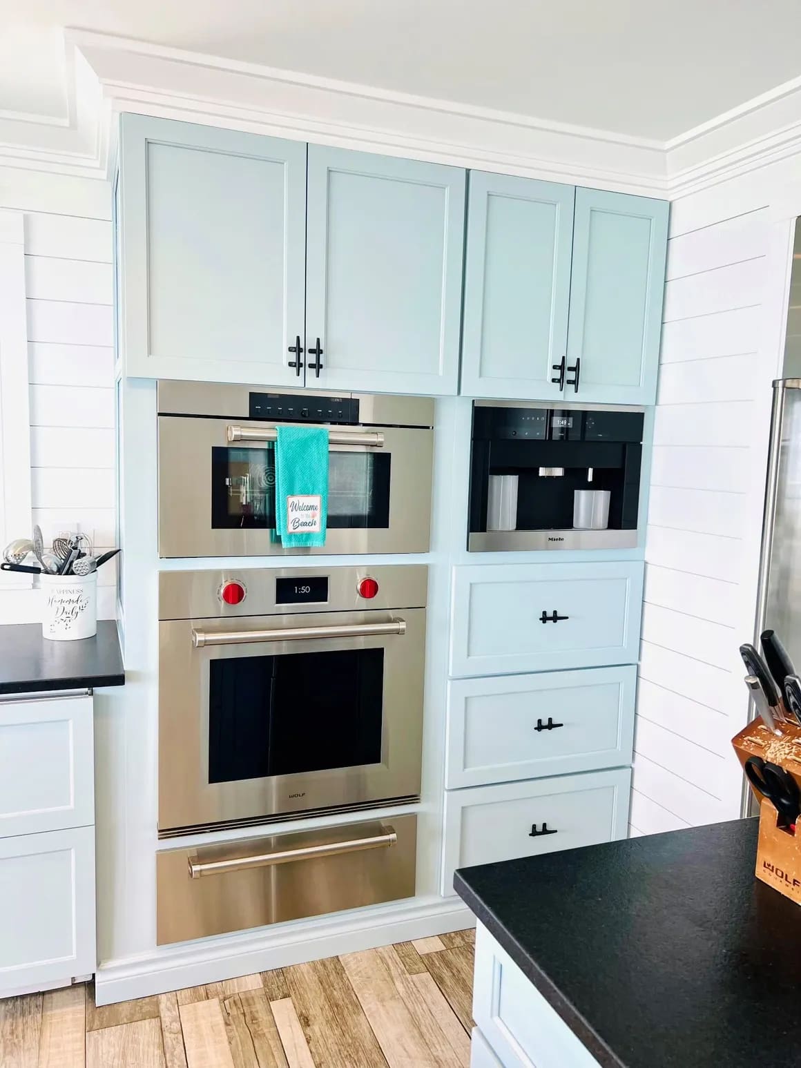 A kitchen with white cabinets and stainless steel appliances.