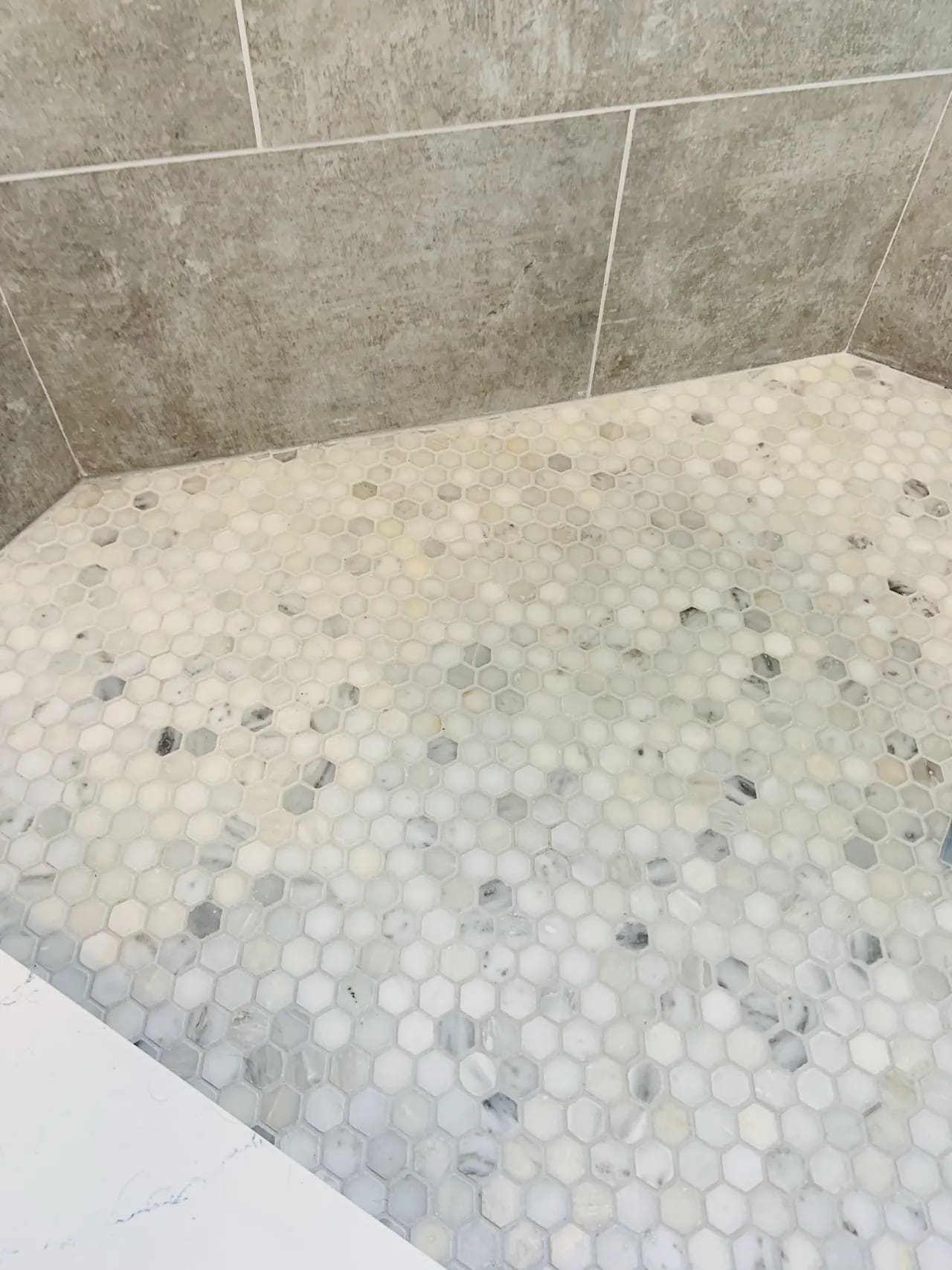 A bathroom with a tiled floor and walls