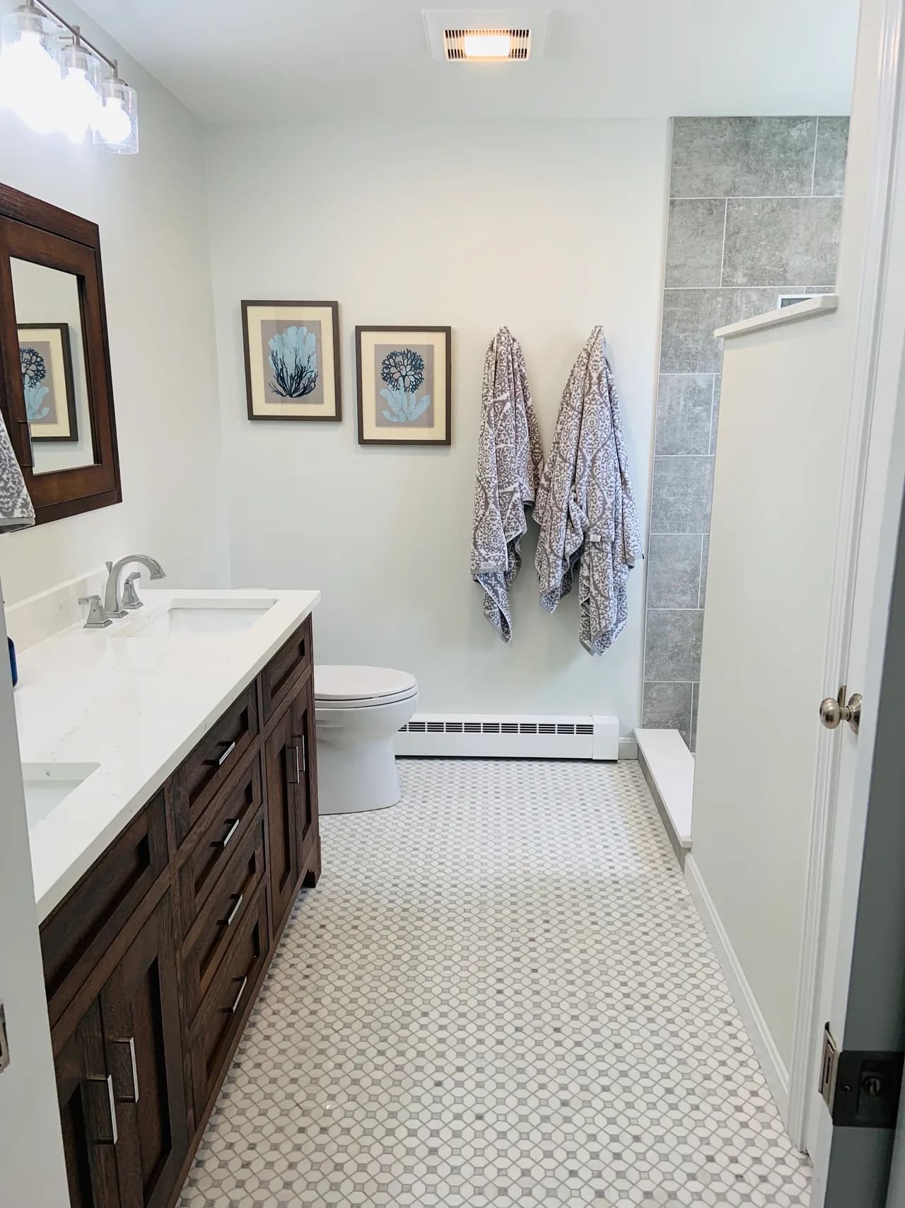 A bathroom with two sinks and a mirror.