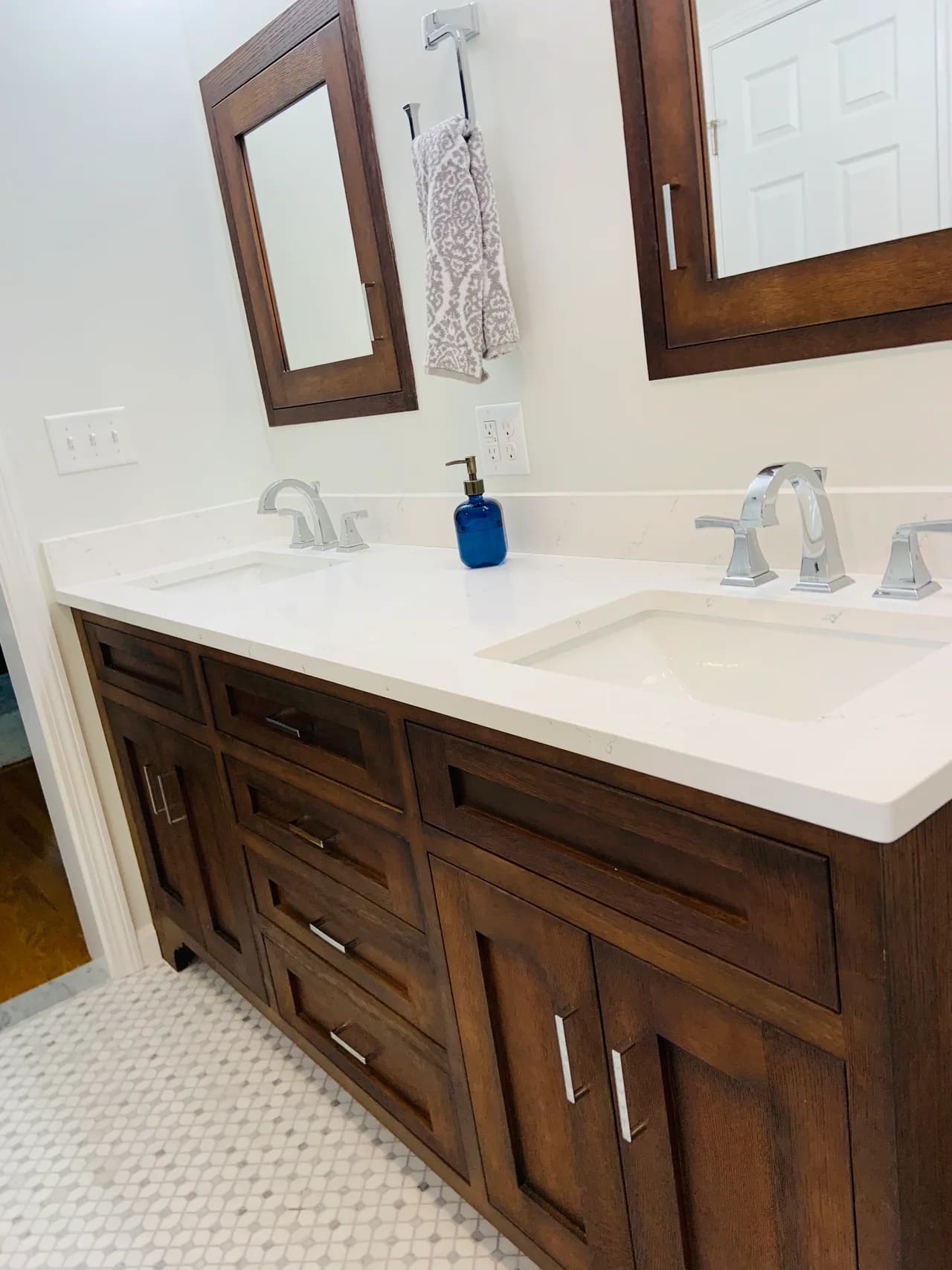 A bathroom with two sinks and mirrors.