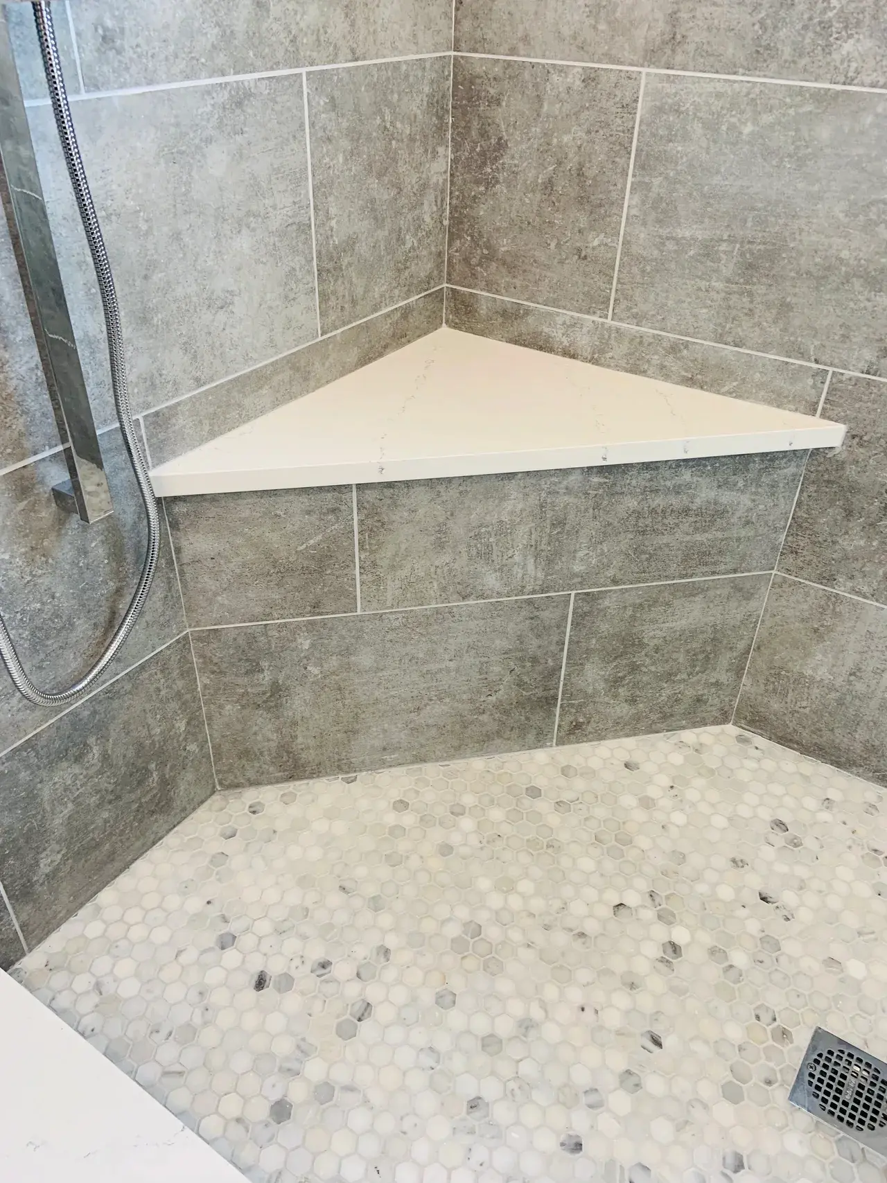 A corner shower with tiled walls and floor