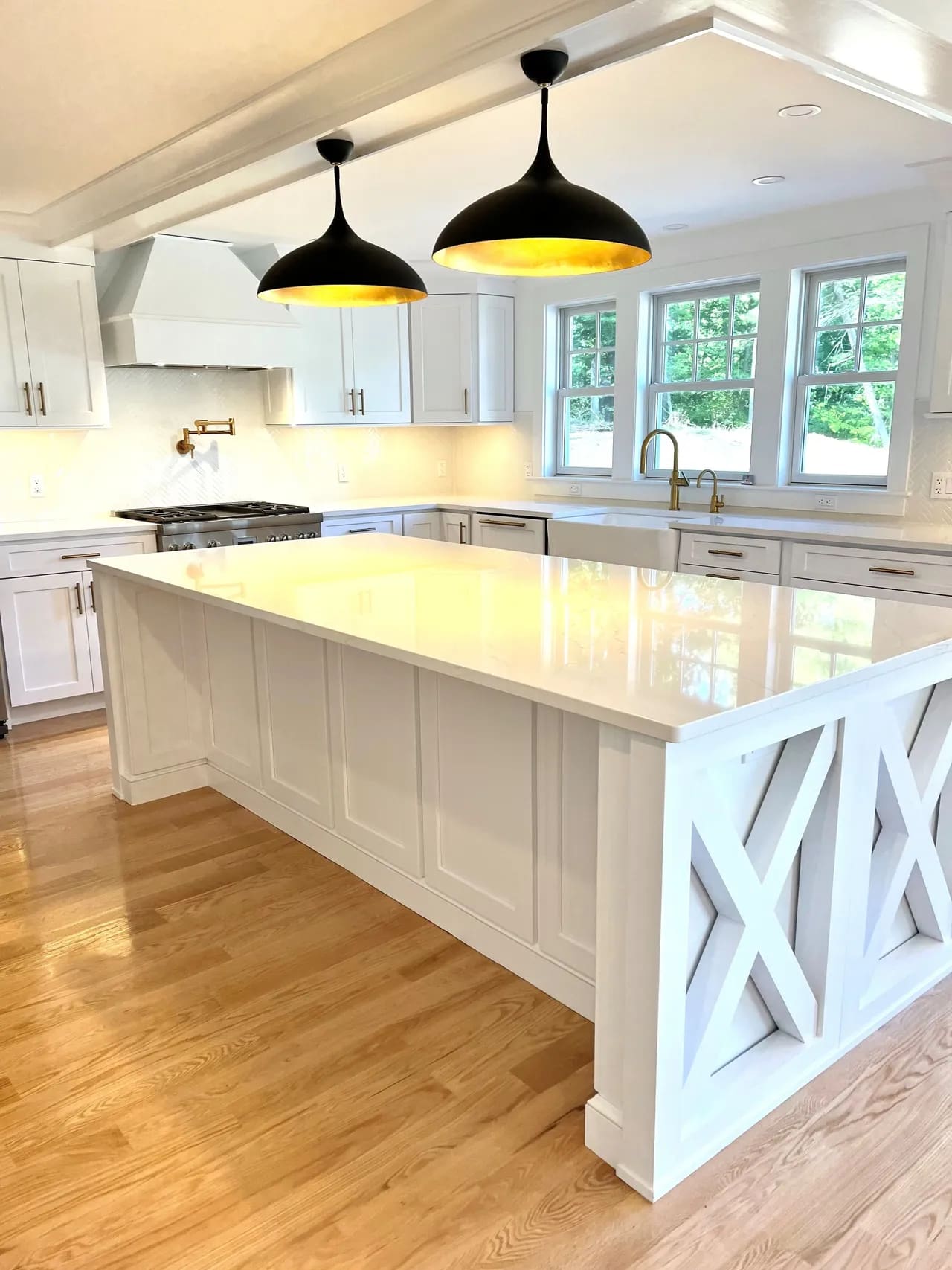 A kitchen with white cabinets and black lights