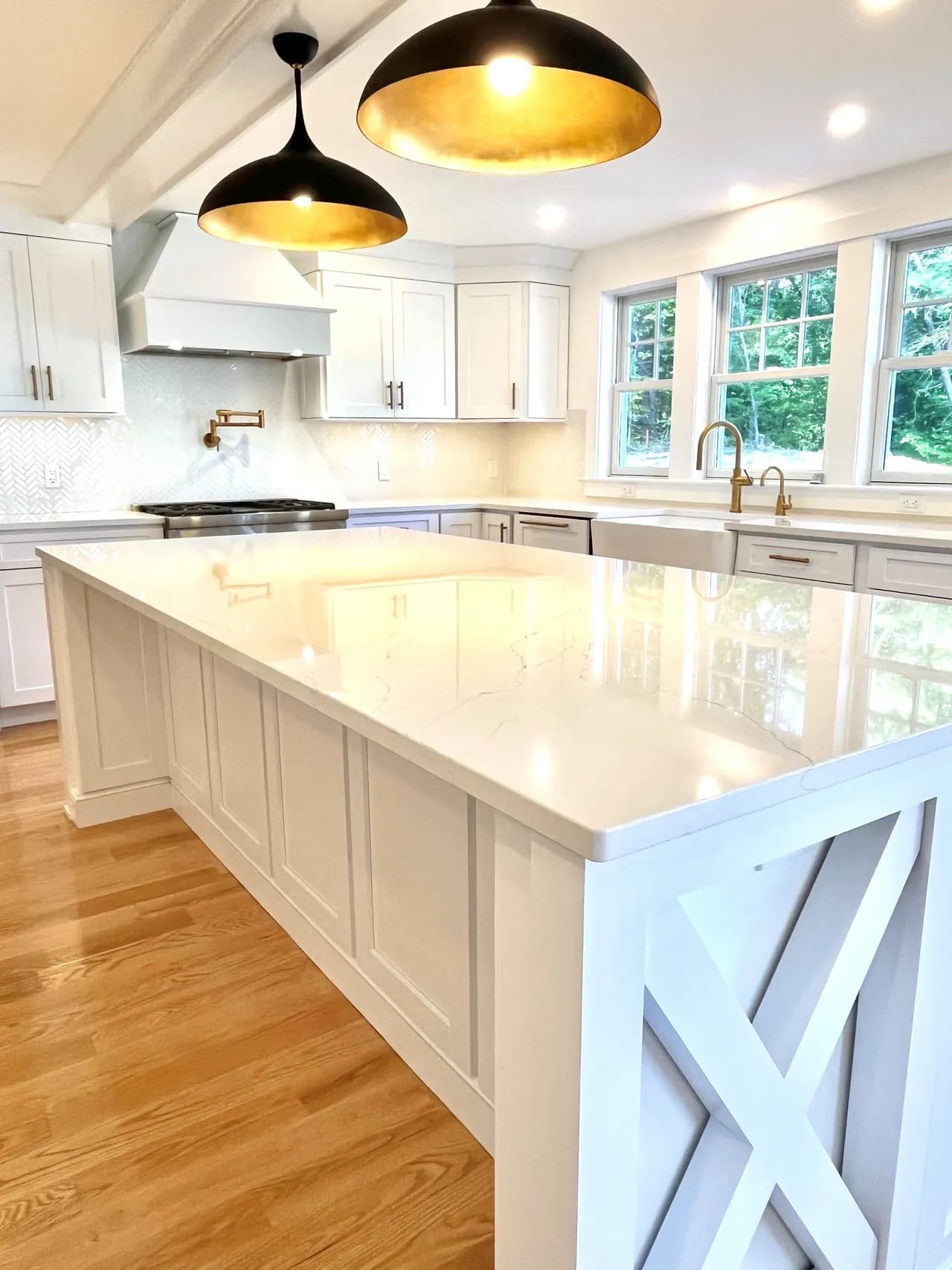 A large kitchen with white cabinets and island