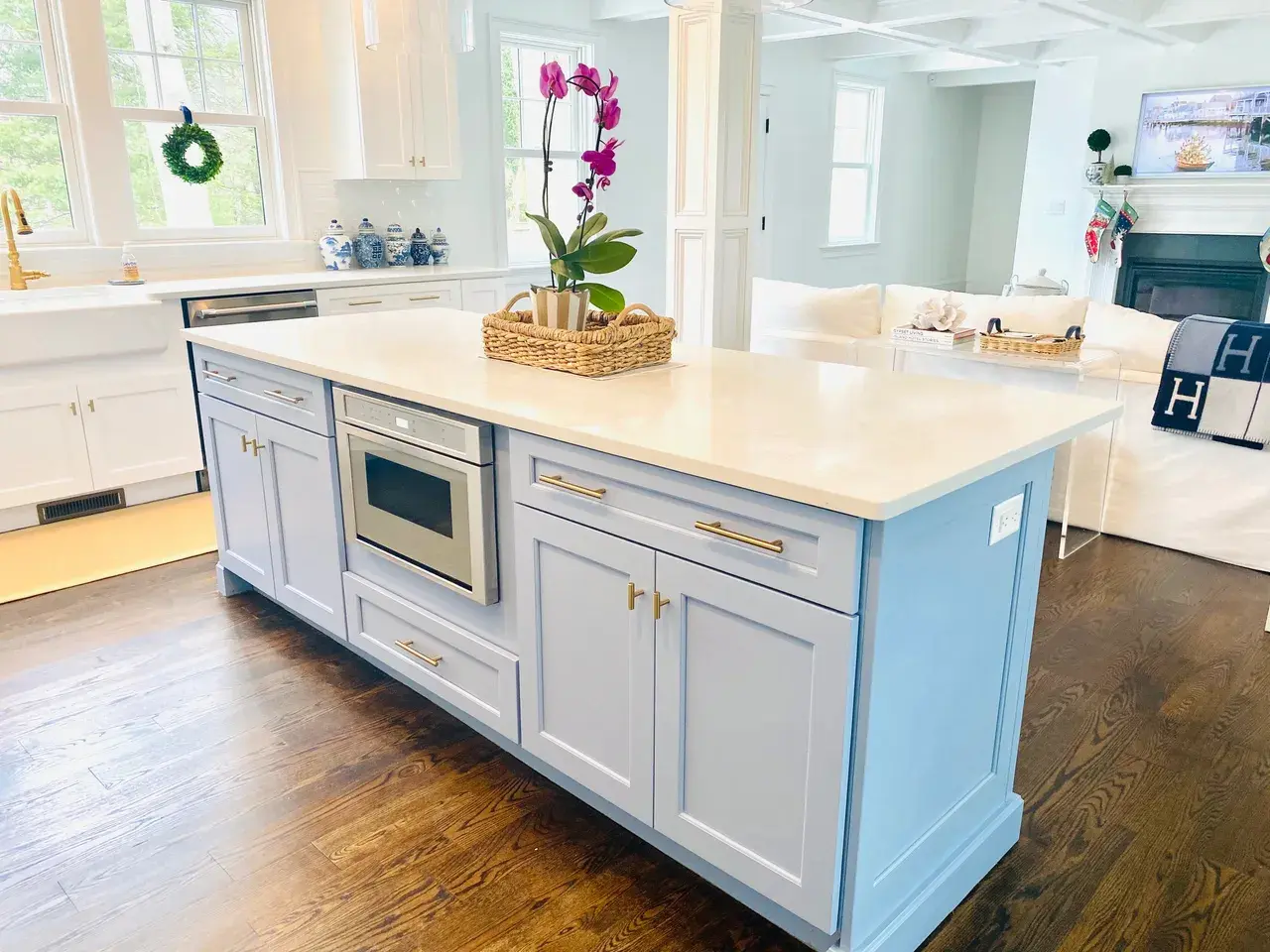 A kitchen with white cabinets and a microwave.