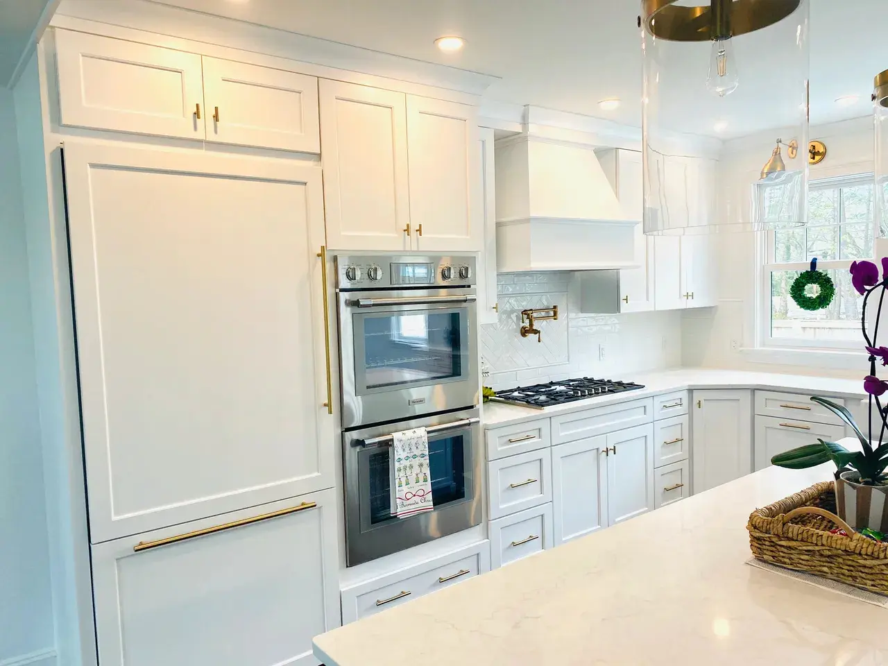 A kitchen with white cabinets and stainless steel appliances.