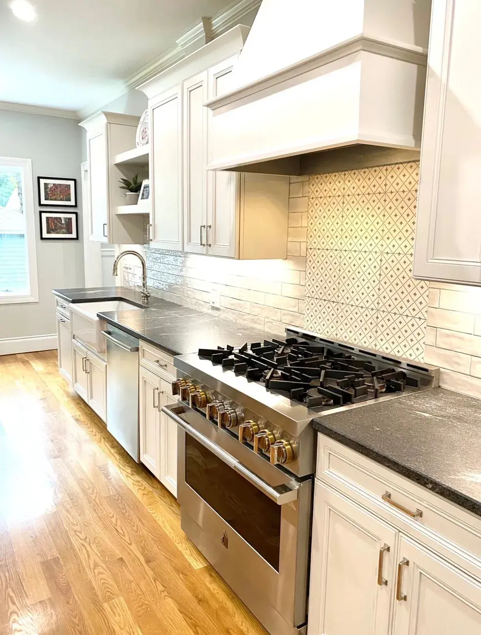 A kitchen with white cabinets and stainless steel appliances.