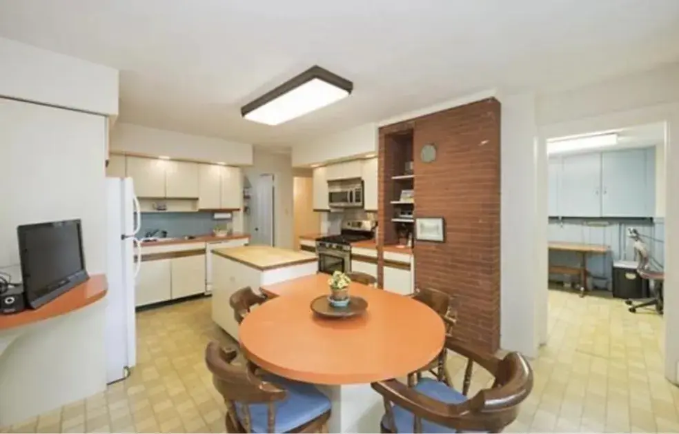 A kitchen with a table and chairs in it