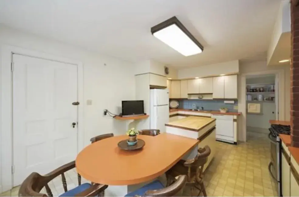 A kitchen with a table and chairs in it