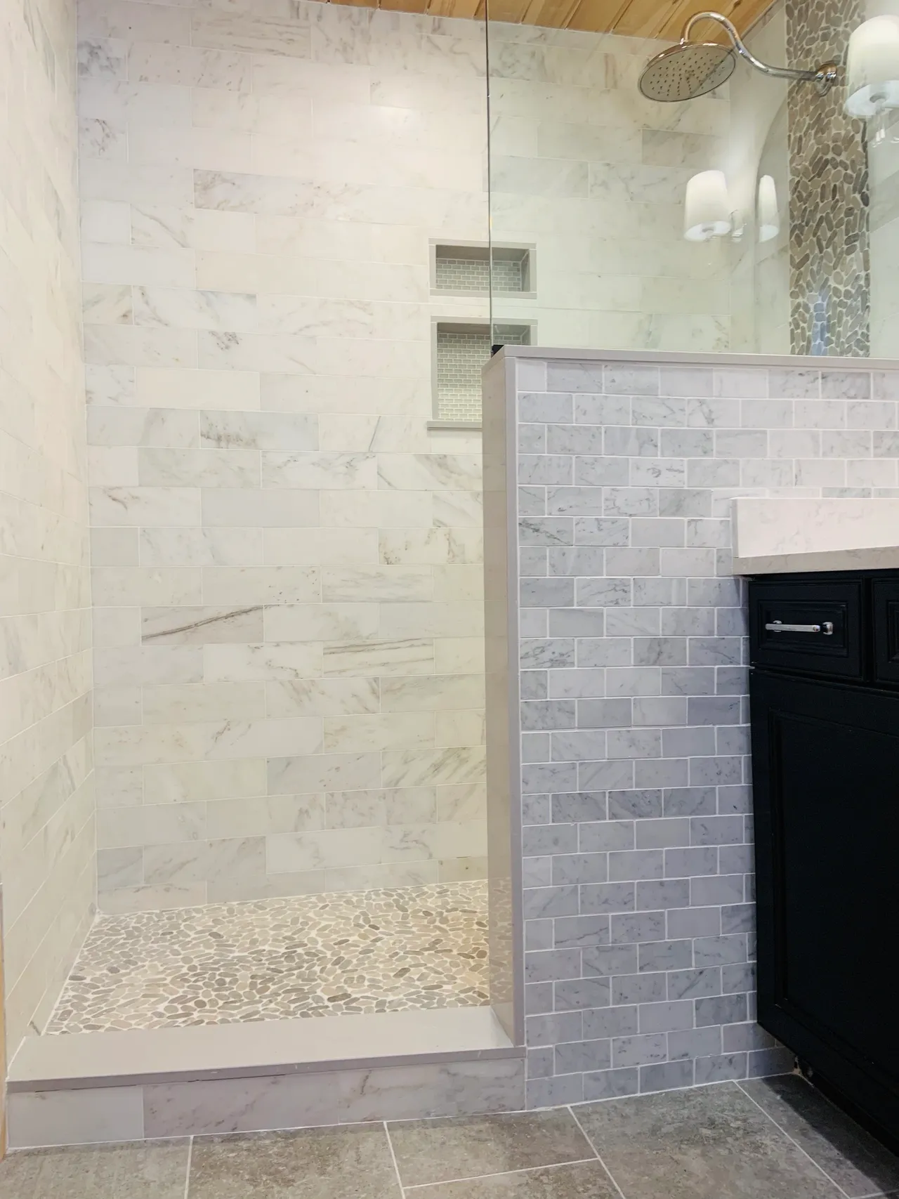 A bathroom with marble walls and floors.