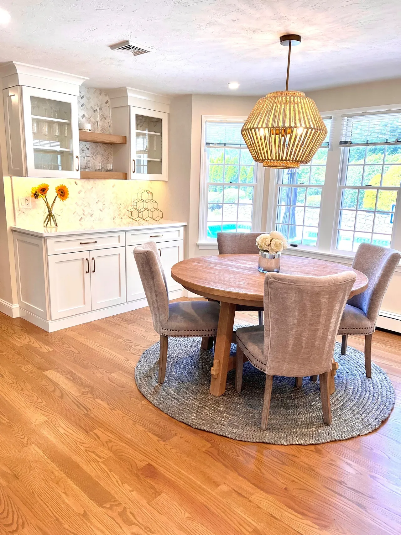 A dining room table with chairs and a light fixture.