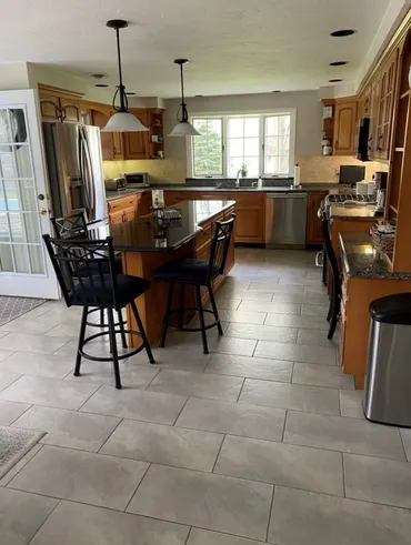 A kitchen with a table and chairs in it