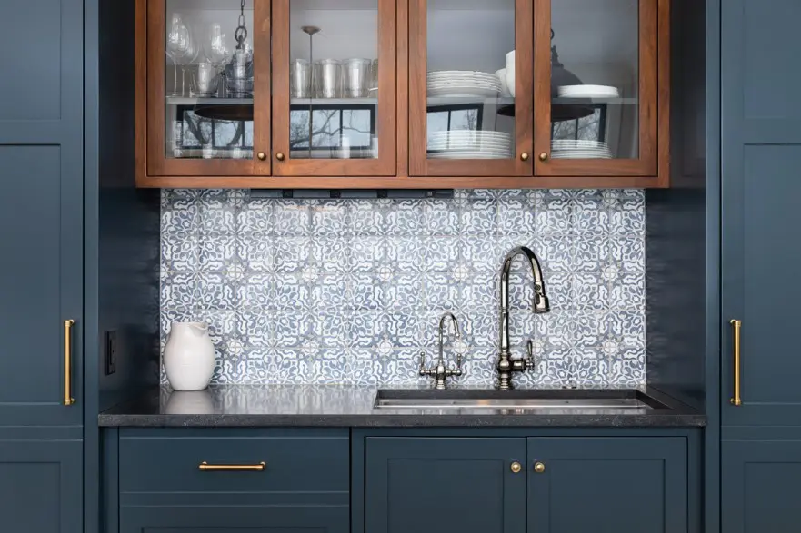 A kitchen with blue cabinets and a sink.