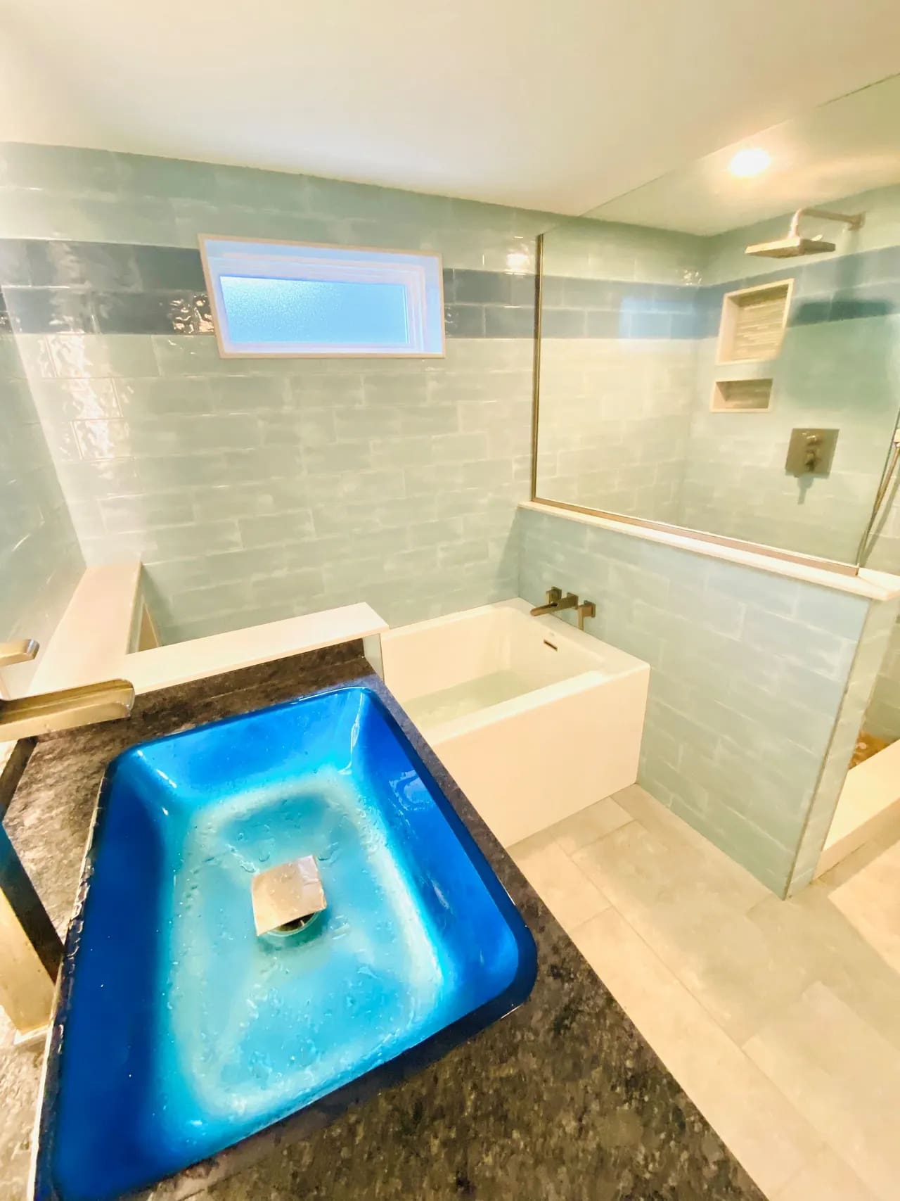 A bathroom with a tub, shower and sink.