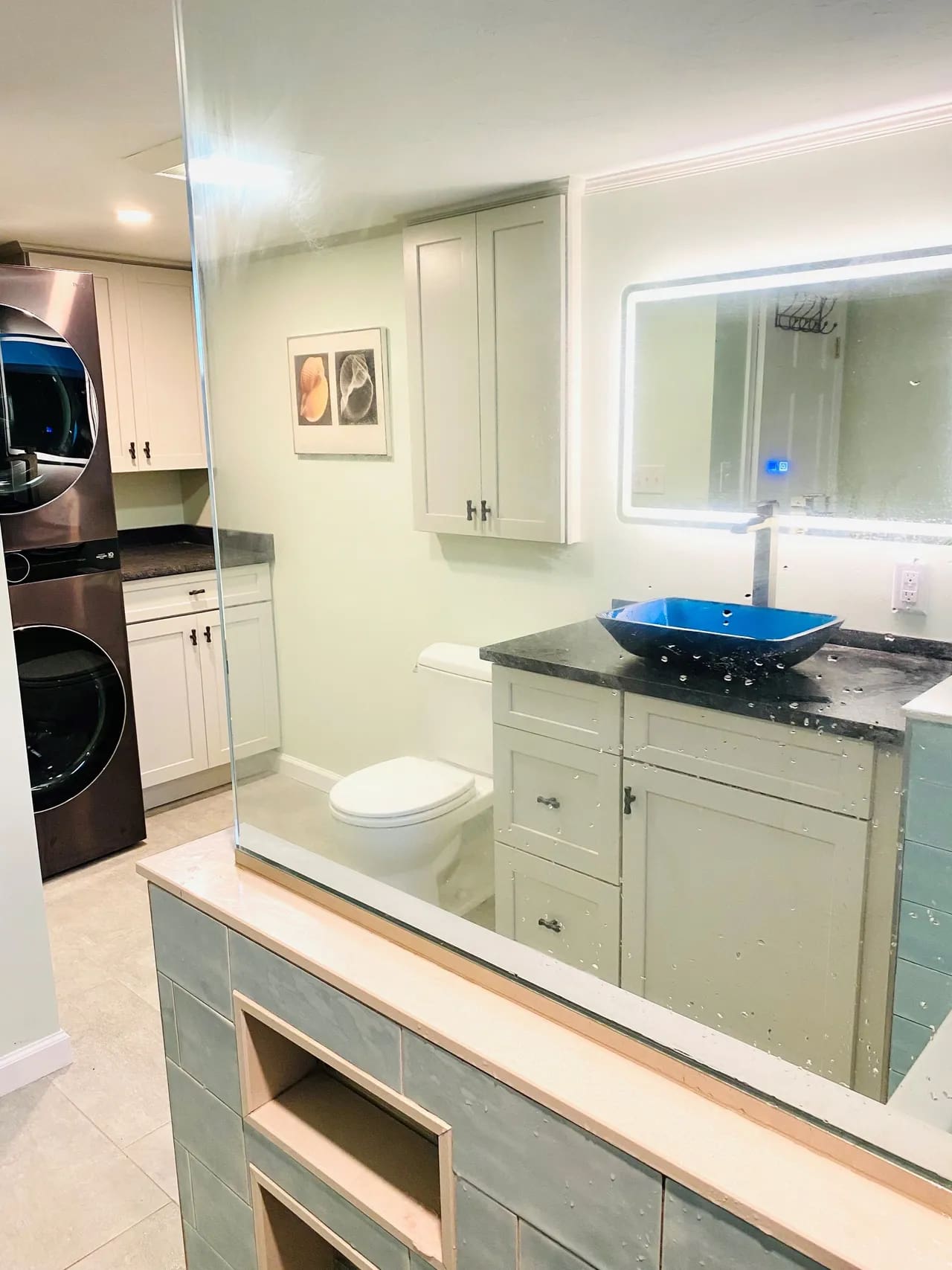 A bathroom with a sink, mirror and toilet.