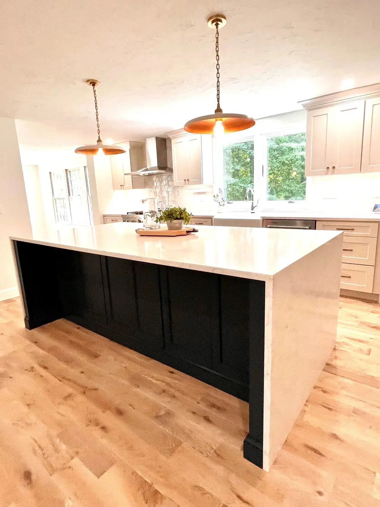 A kitchen with an island and wooden floors