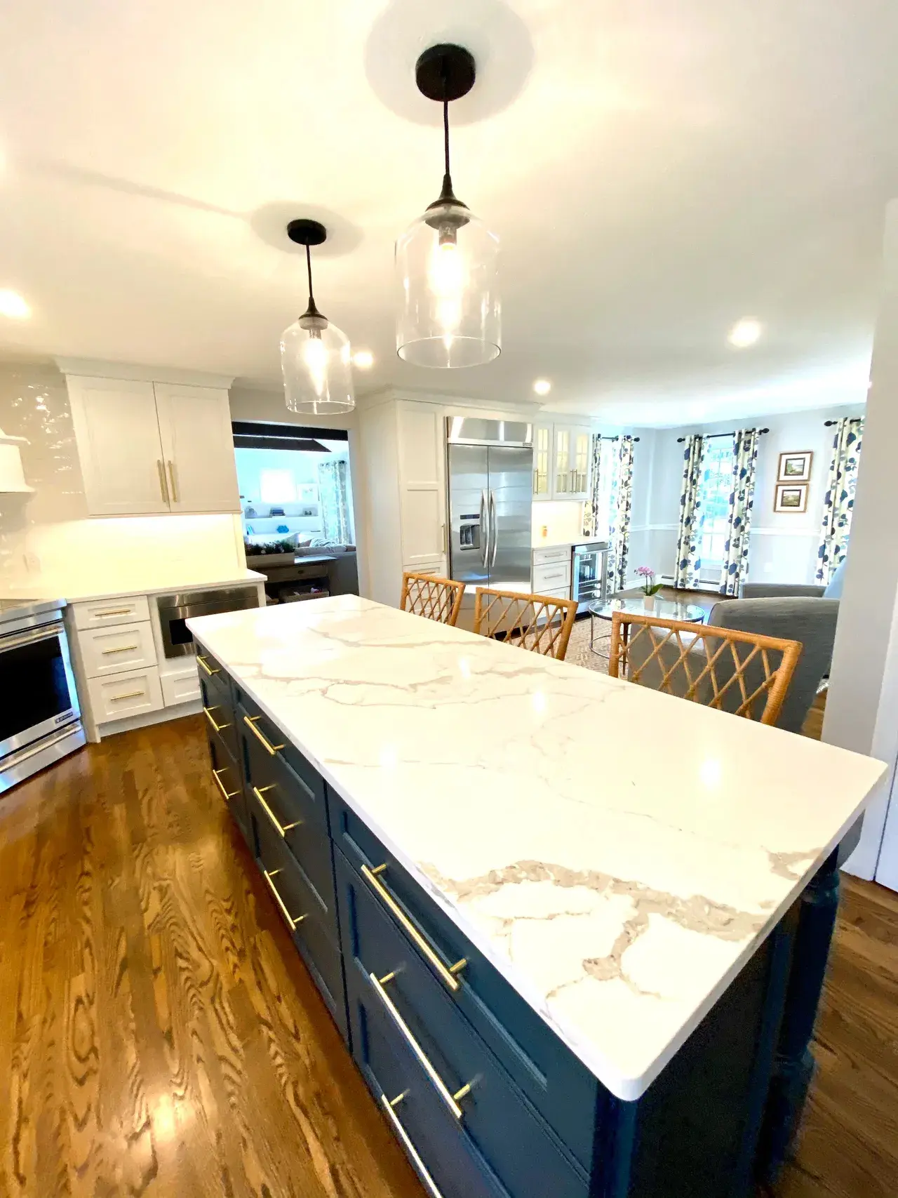 A kitchen with a large island and white cabinets.