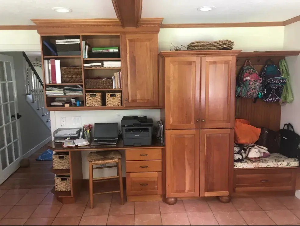 A room with many wooden cabinets and drawers.