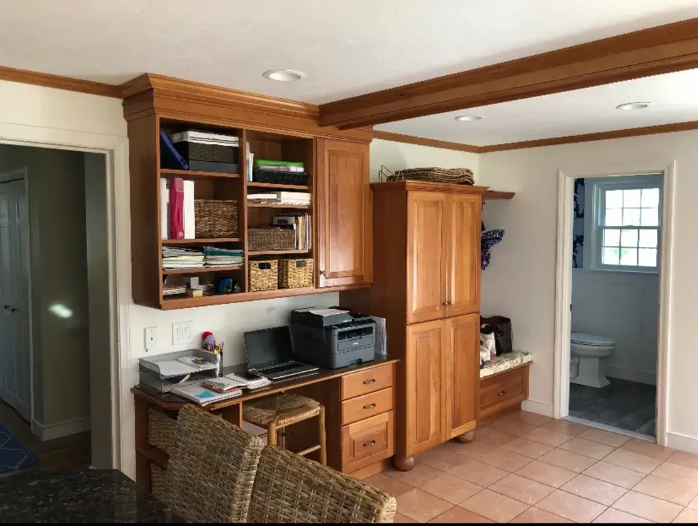 A room with a desk and cabinets in it