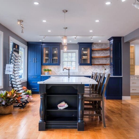 A kitchen with blue cabinets and wooden floors.