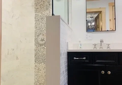 A bathroom with a sink, mirror and counter.